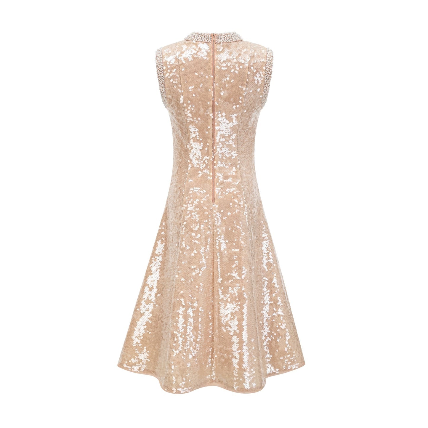 A woman wearing a sparkling midi length dress with sequins and faux pearls adorning the fabric standing in an elegant pose
