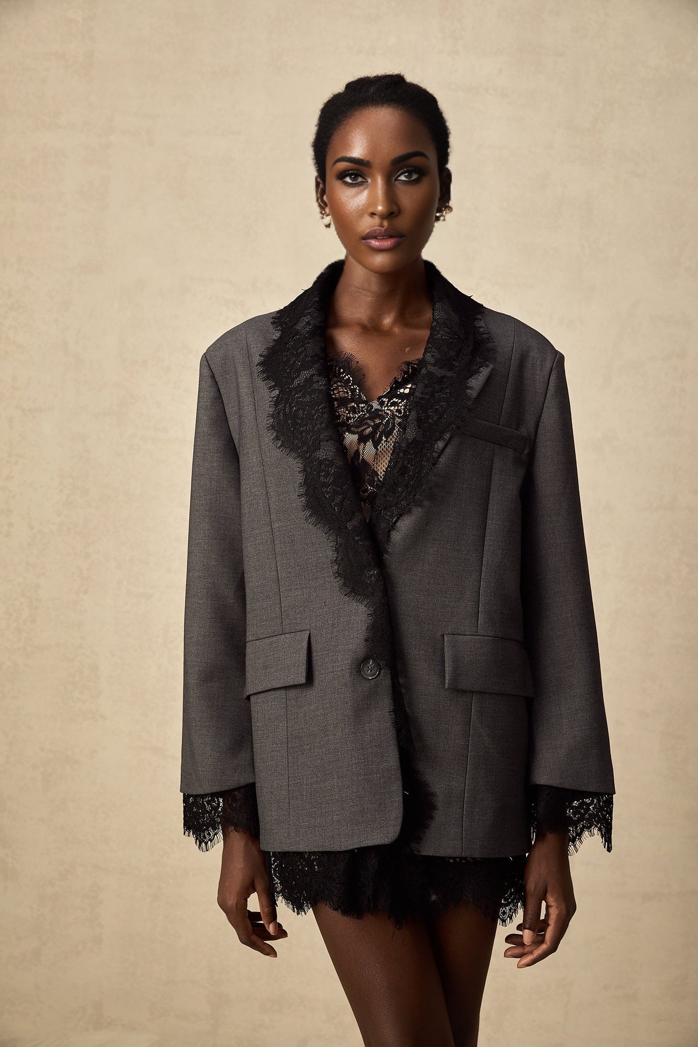 A grey blazer with lace panel detailing