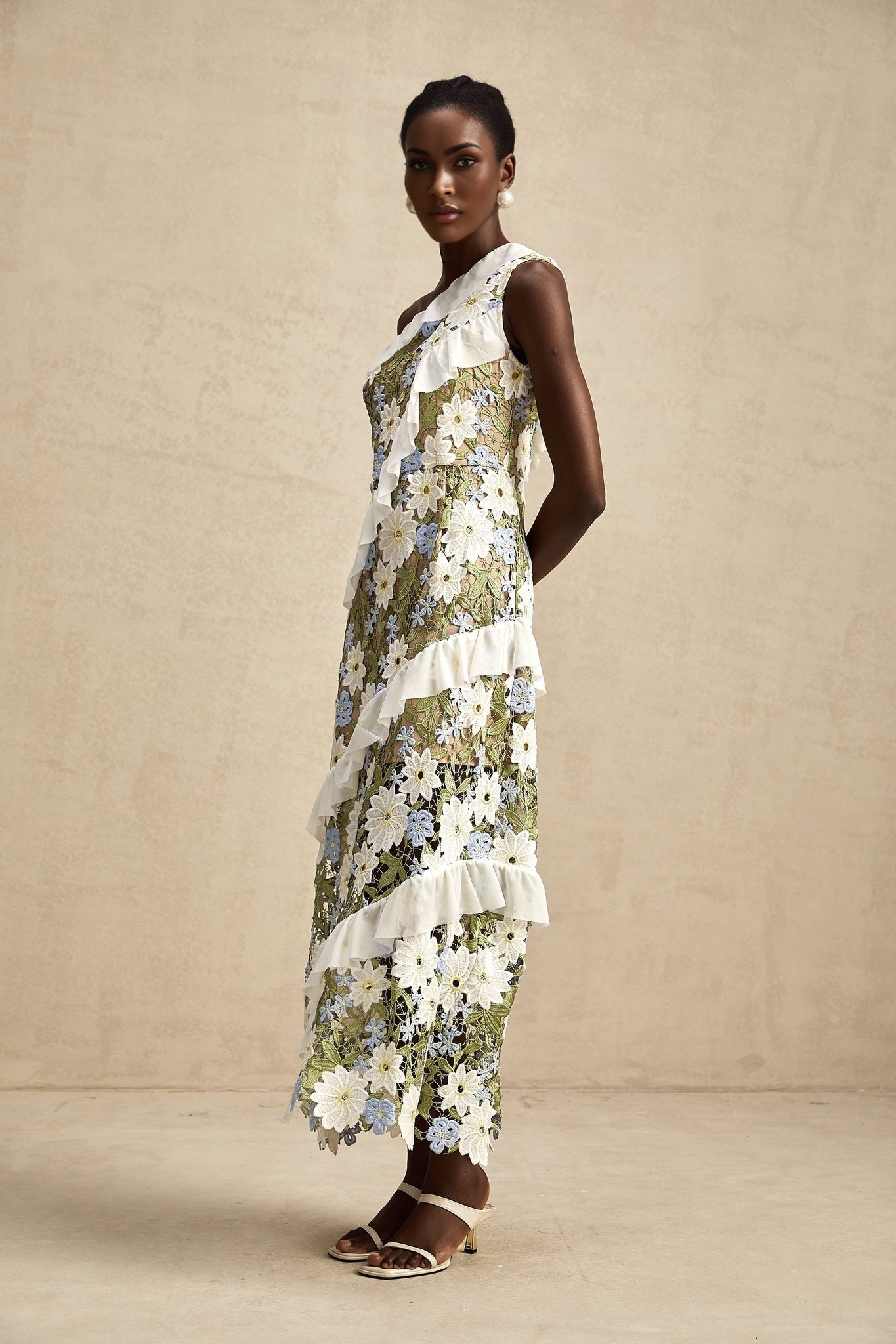 A floral embroidered midi dress with a Clémence design featuring delicate flower patterns on a light fabric