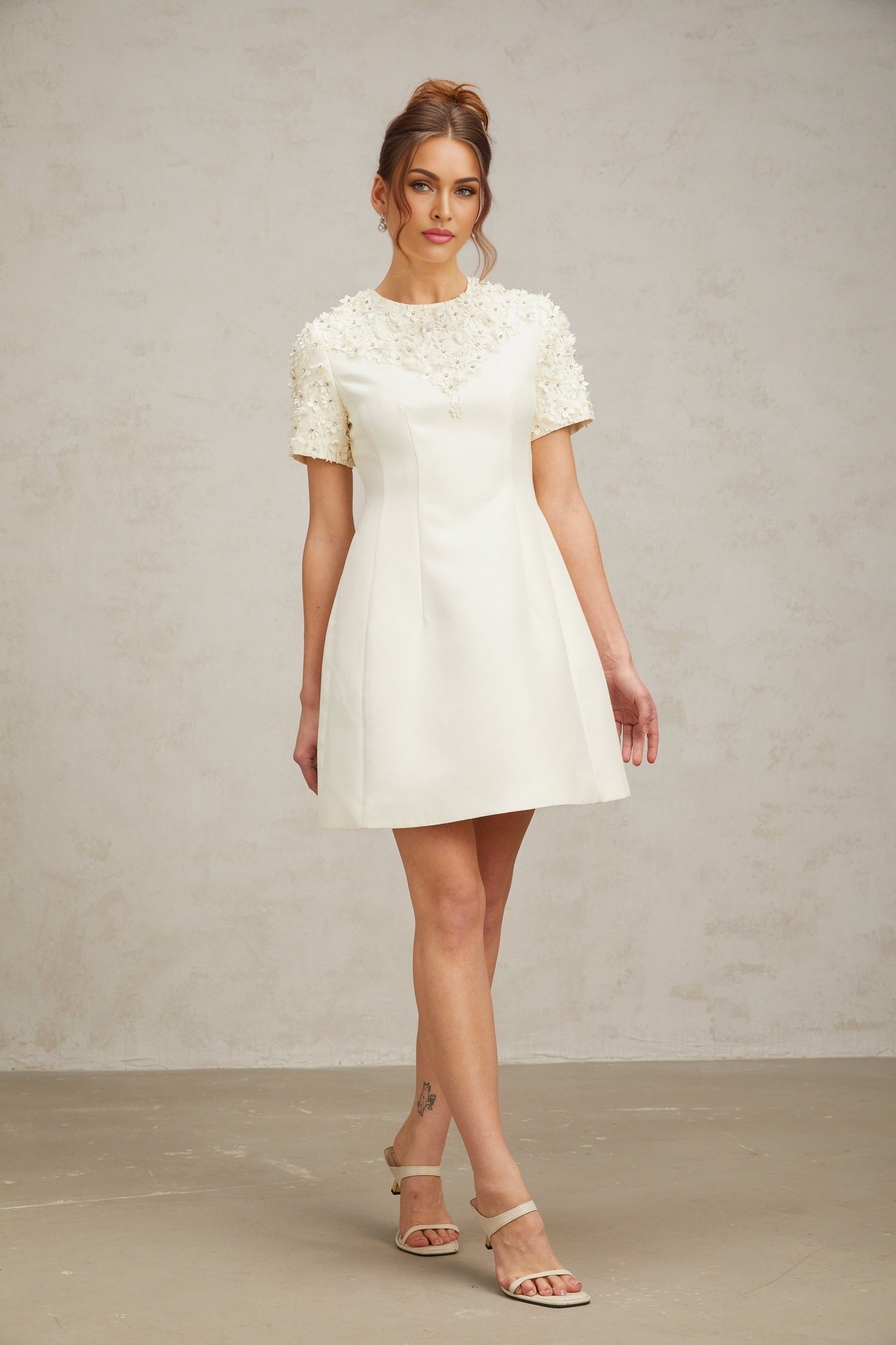 Heres a simple alt text for the product image based on the title
Adrienne mini dress with floral appliques on fabric short length sleeveless design feminine silhouette