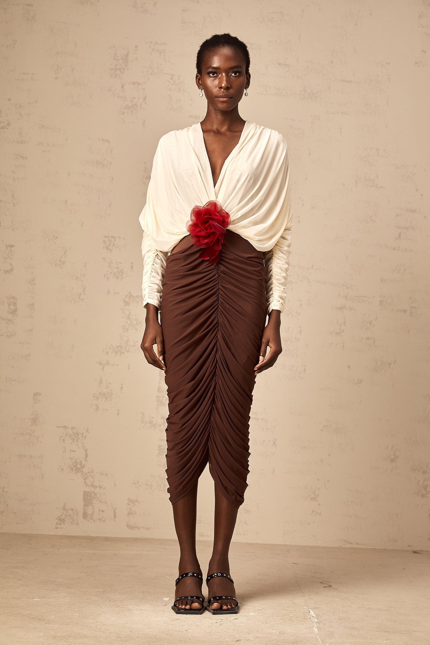 A midi dress with ruched detailing featuring color blocking and a flower brooch accent named Leontine
