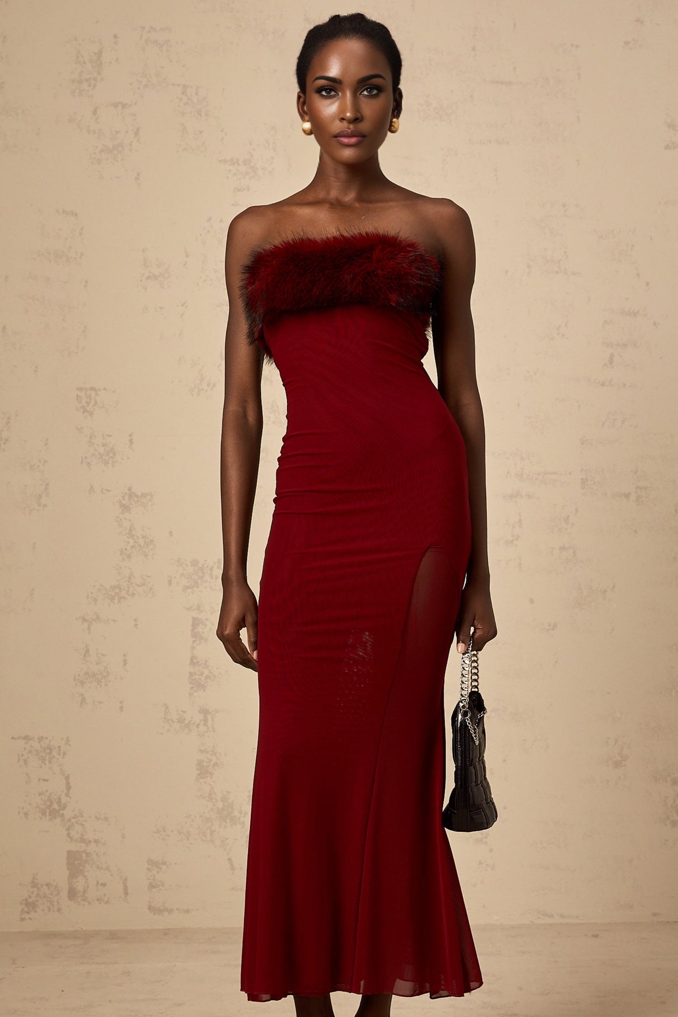 A red midi dress with faux fur trim and offshoulder mesh sleeves
