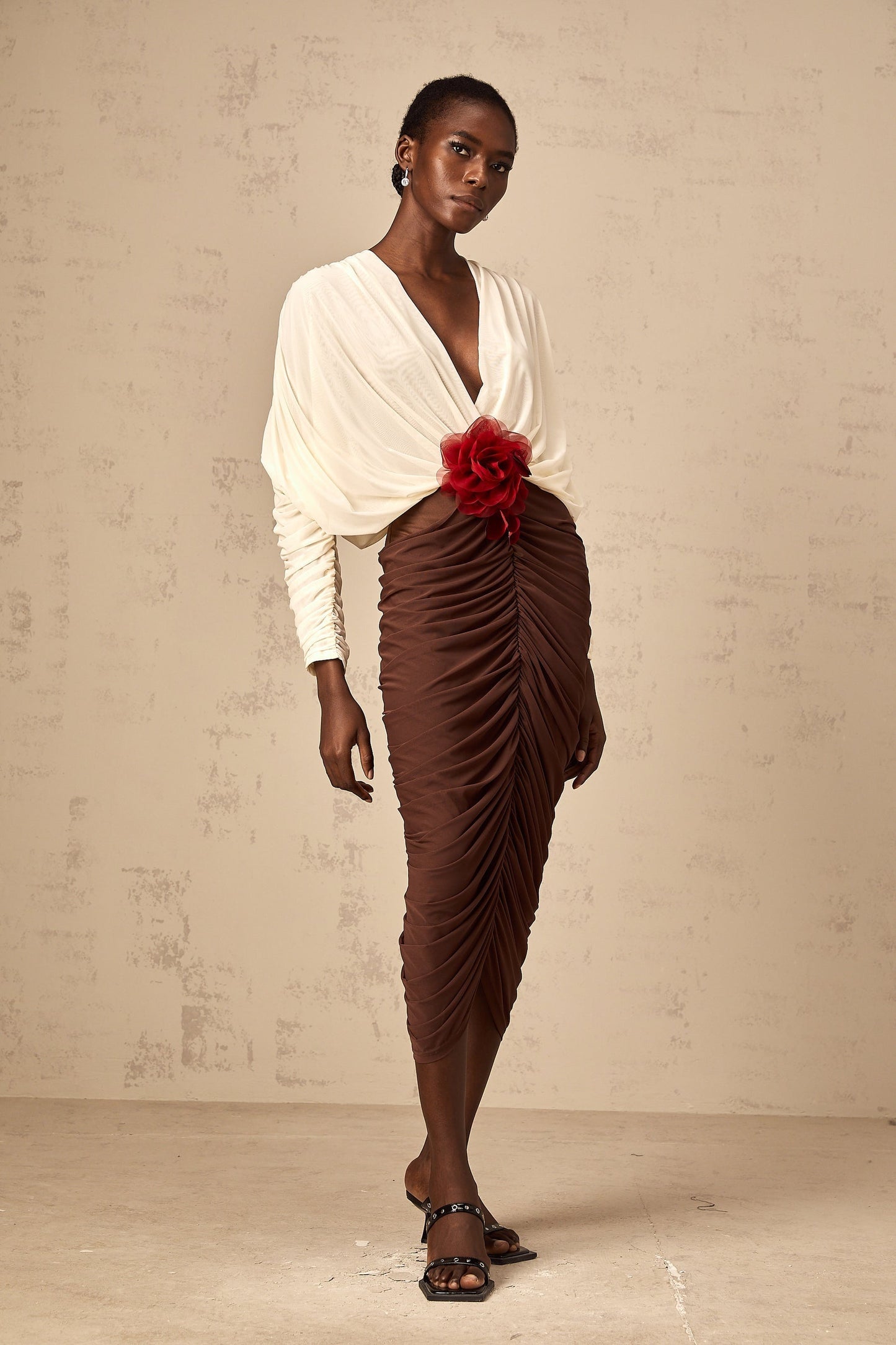 A colorblocked midi dress with ruched detailing and a floral brooch accent named Leontine