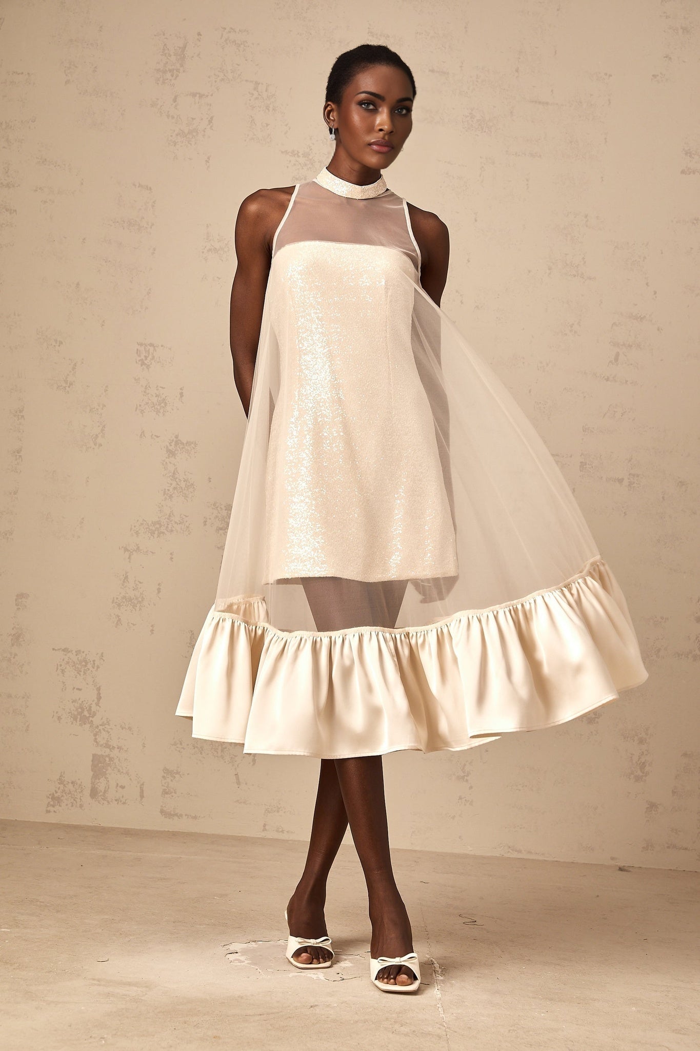 A layered midi dress with a tulle panel and sequin embellishments named Josette featuring a combination of shimmering fabric and delicate sheer overlay
