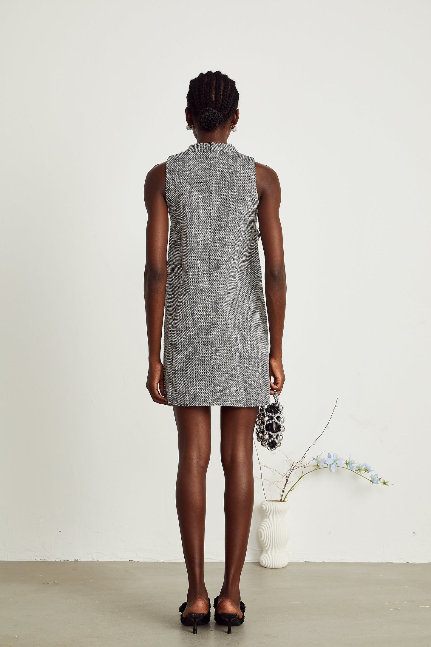 A sleeveless mini dress with faux flower details called Nadege