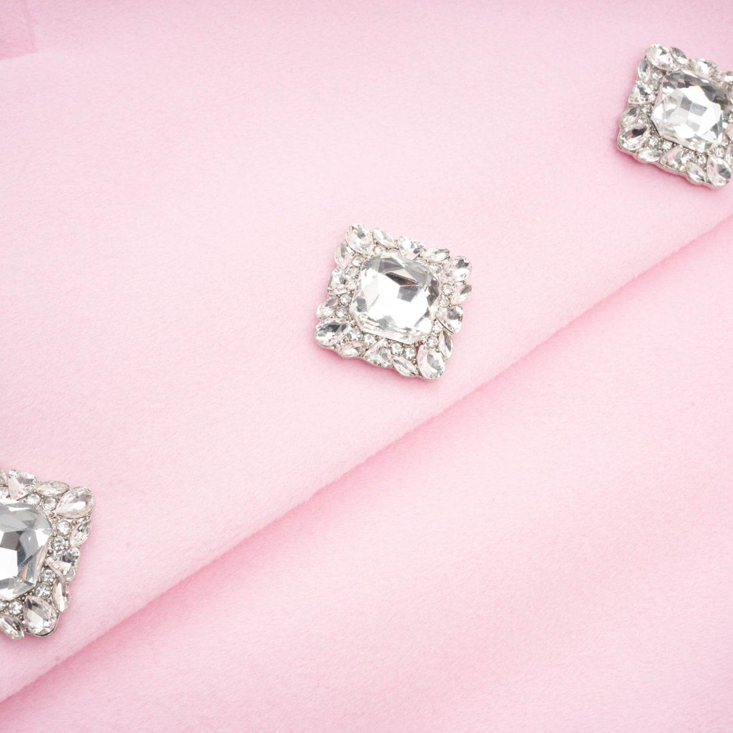 A pink overcoat made of faux fur named Louisette shown on a plain background