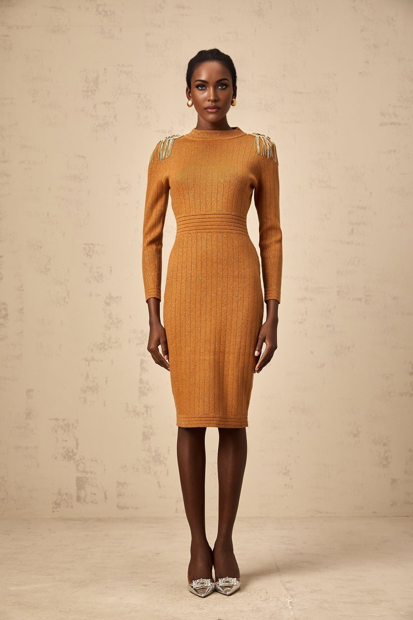 Woman wearing a navy blue ribbed knit midi dress with epaulet details on the shoulders