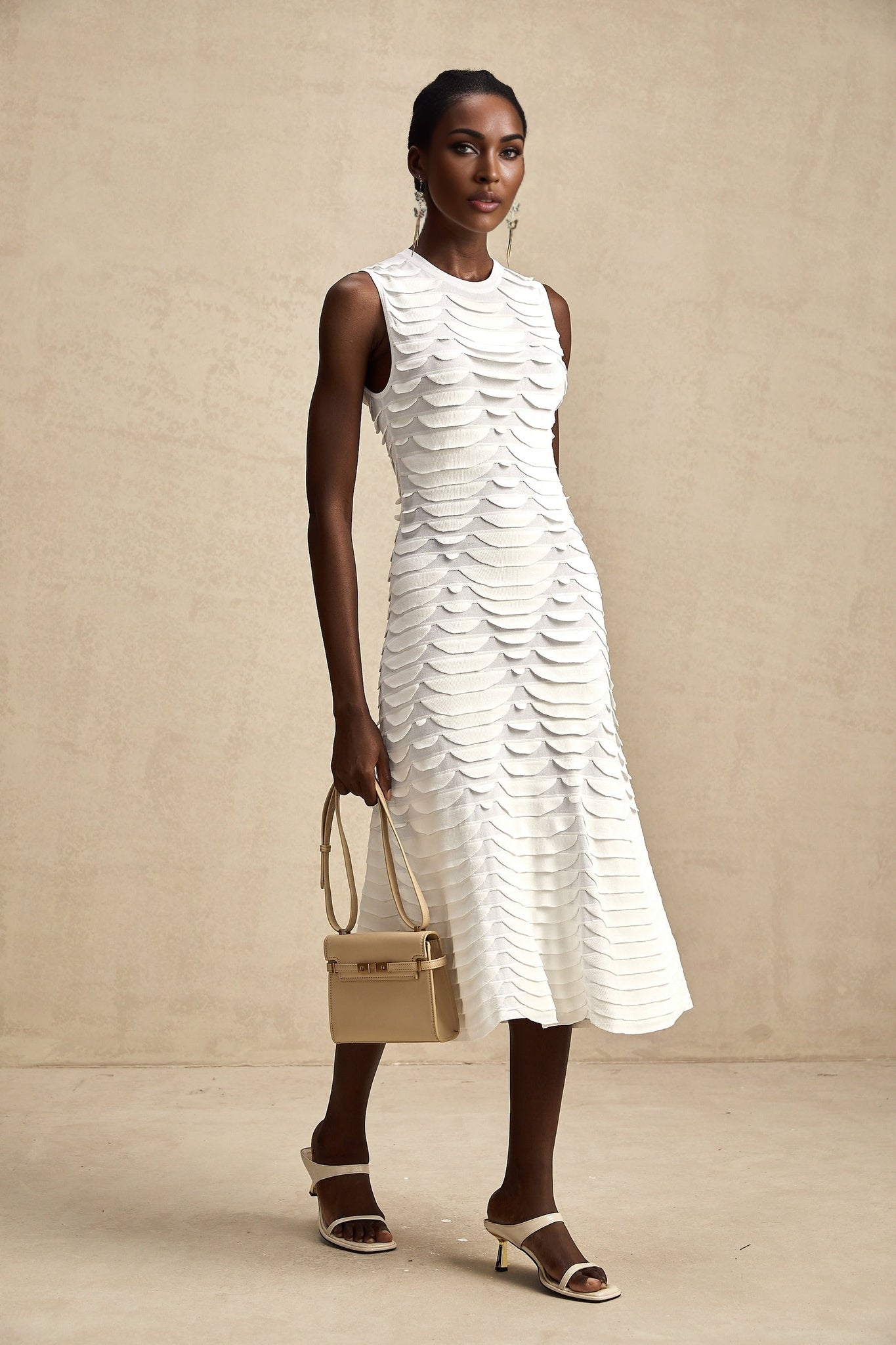 Woman wearing a snake pattern midi dress with flared godet inserts and long sleeves