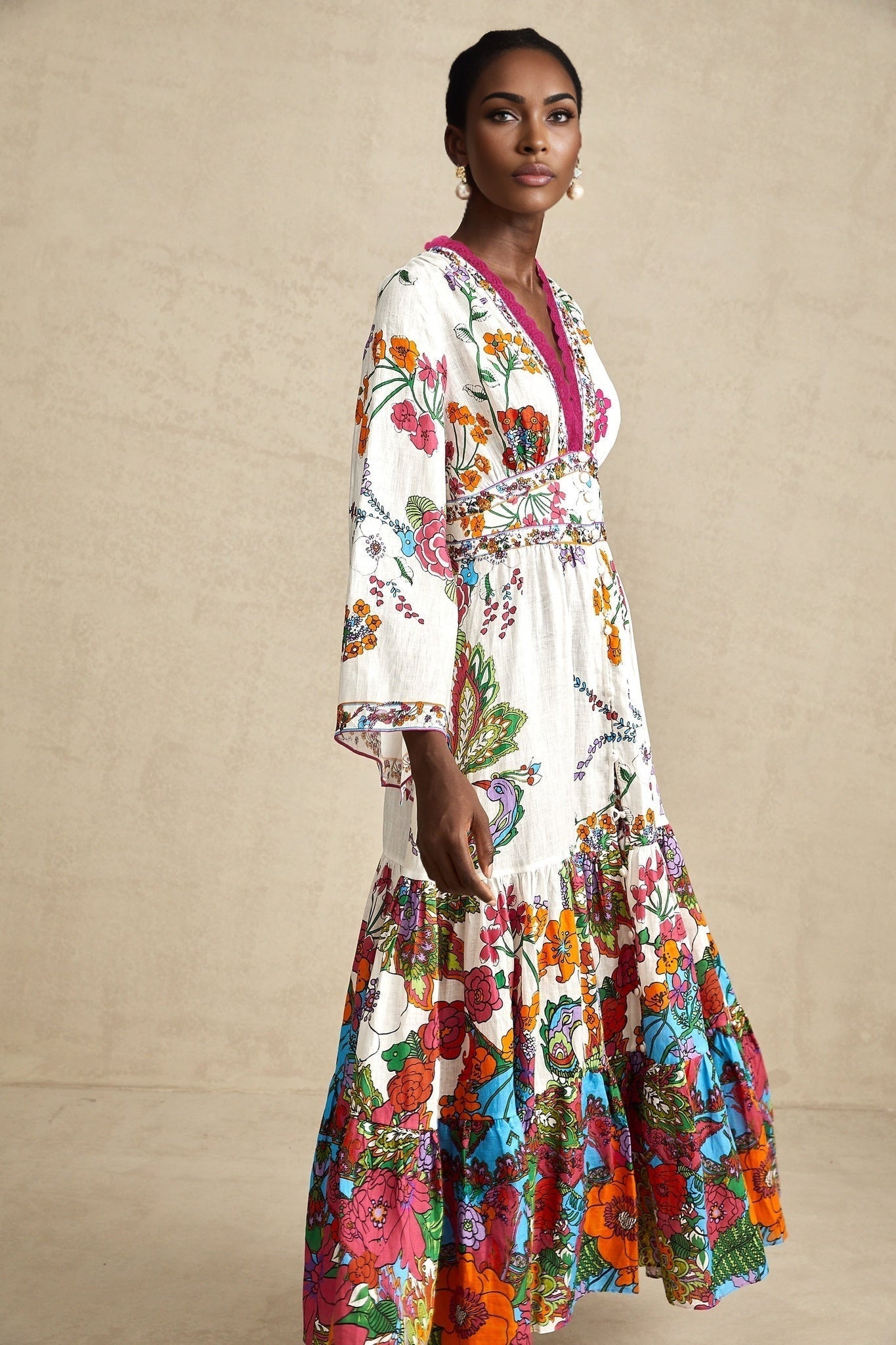 Woman wearing floral print midi dress with Vneck and flowing skirt in soft pastel colors