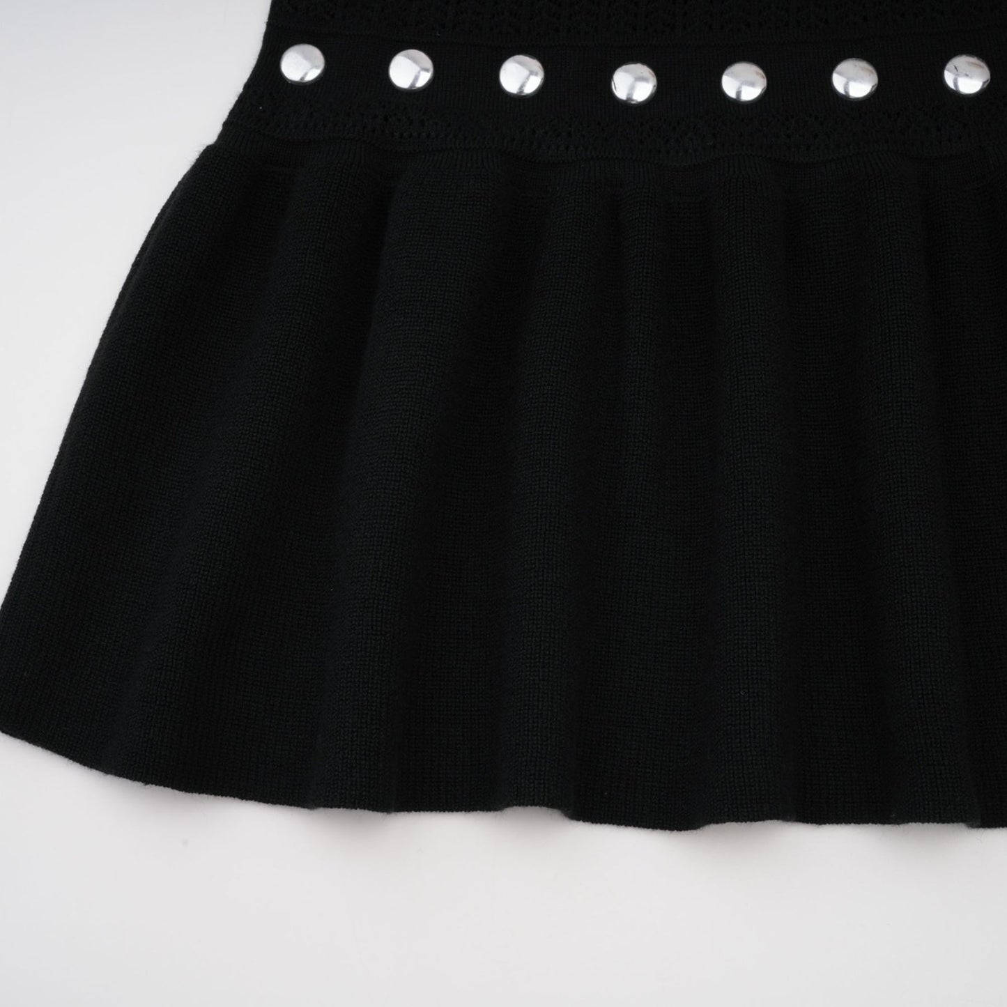 A black Chloe maxi dress with crochet knit detailing and studded embellishments