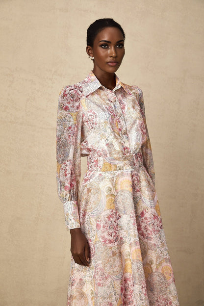 A matching set consisting of a cherry pink shirt and skirt both featuring a pattern print design