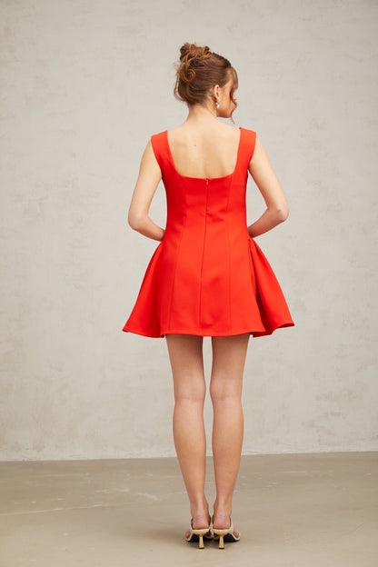 A red mini dress with a square neckline and puff sleeves in a Margherita style