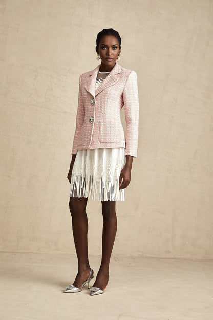 A pink tweed blazer with crystal embellishments and a checked pattern