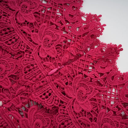 A long red maxi dress with scalloped lace panels featuring a delicate pattern