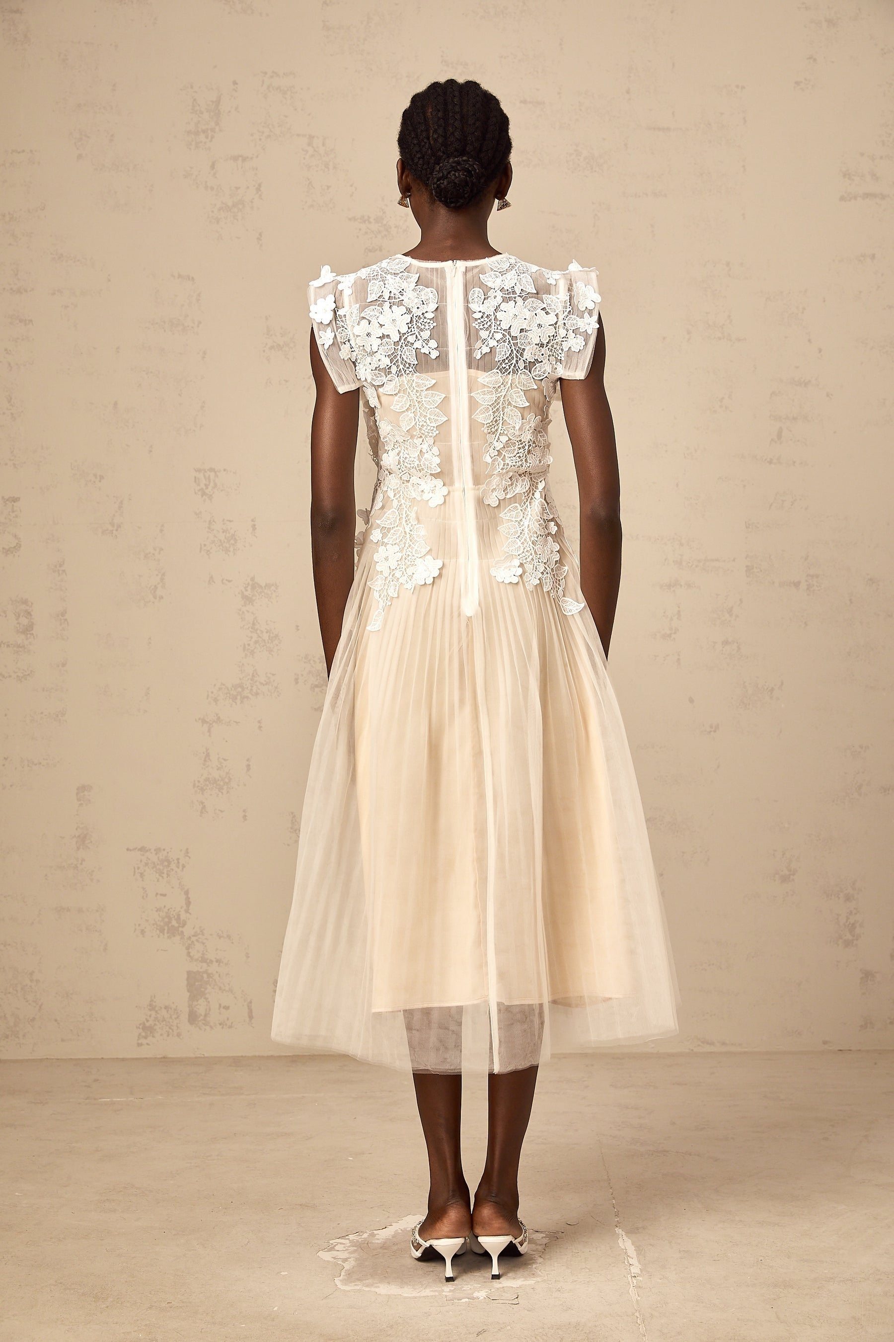 White tulle midi dress with colorful floral appliques scattered across the bodice and skirt