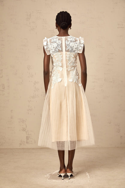 White tulle midi dress with colorful floral appliques scattered across the bodice and skirt