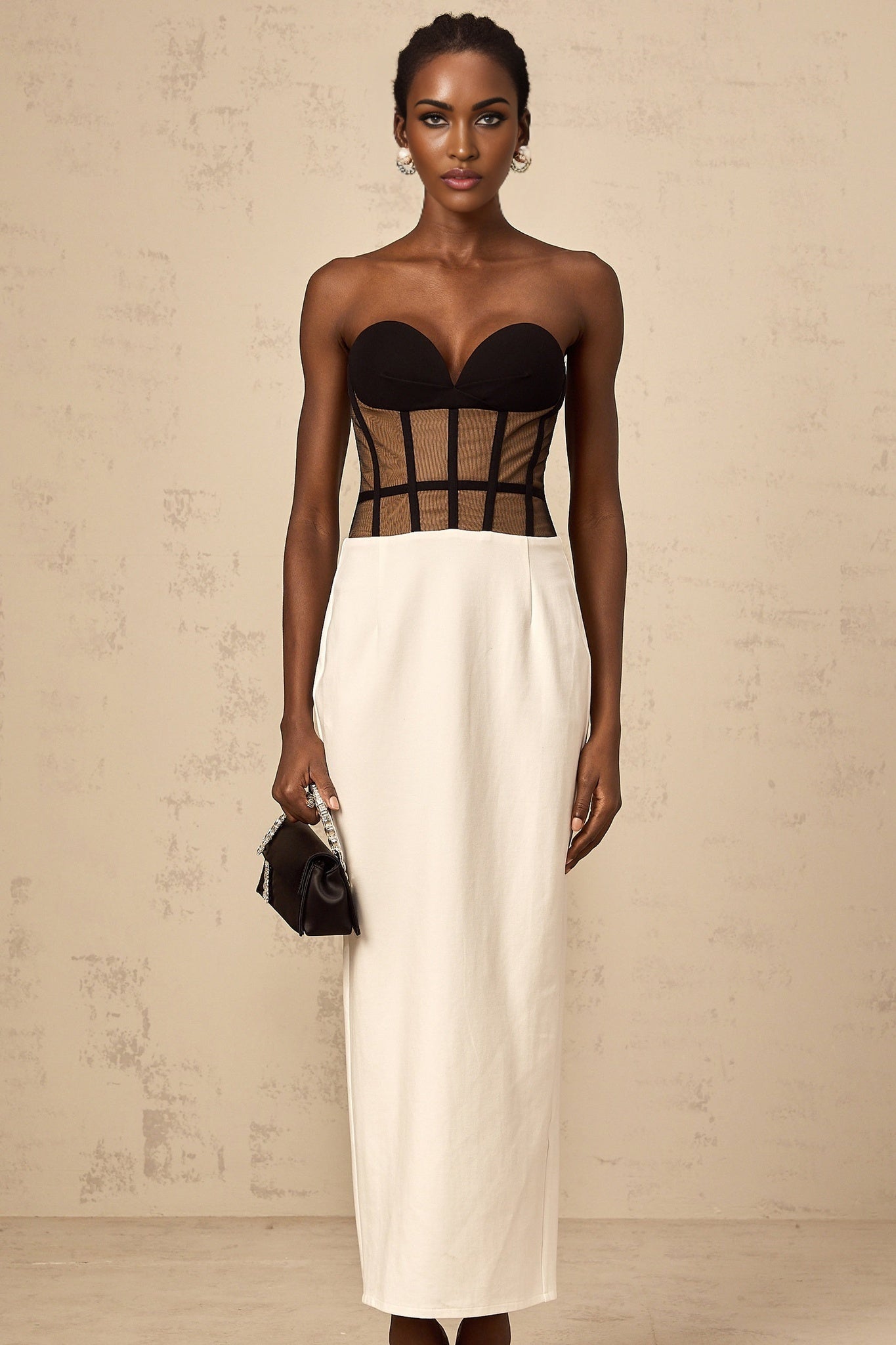 A long sheer maxi dress with contrasting colors featuring a corset bodice design named Enora