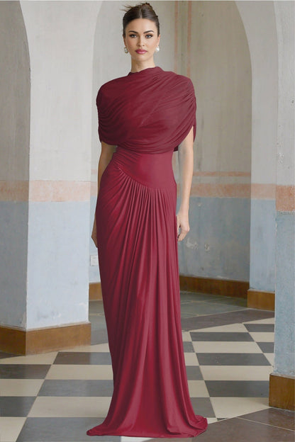 A red asymmetric maxi dress with pleats worn by a model standing against a plain background