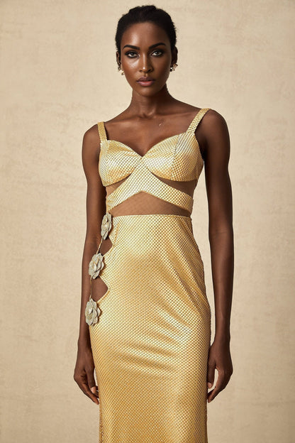 A long golden maxi dress with floral cutout patterns and a flowing silhouette named Giulia