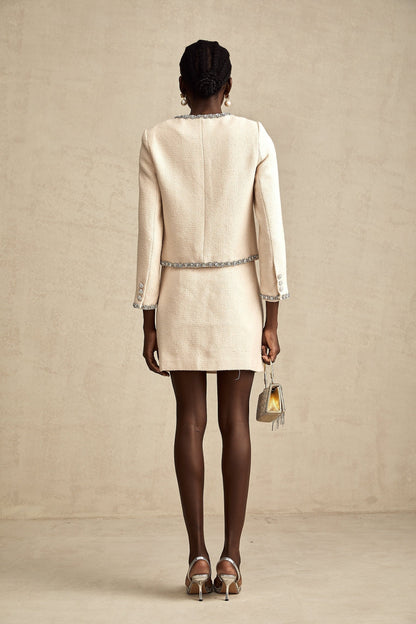 Woman wearing beige tweed cardigan and matching skirt with crystal embellishments Elisabeth set