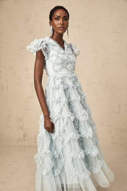 A blue midi dress with ruffles and small dot details named Corinna