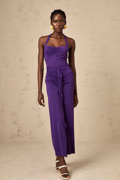 A purple halterneck midi dress with ruched detailing on a female model