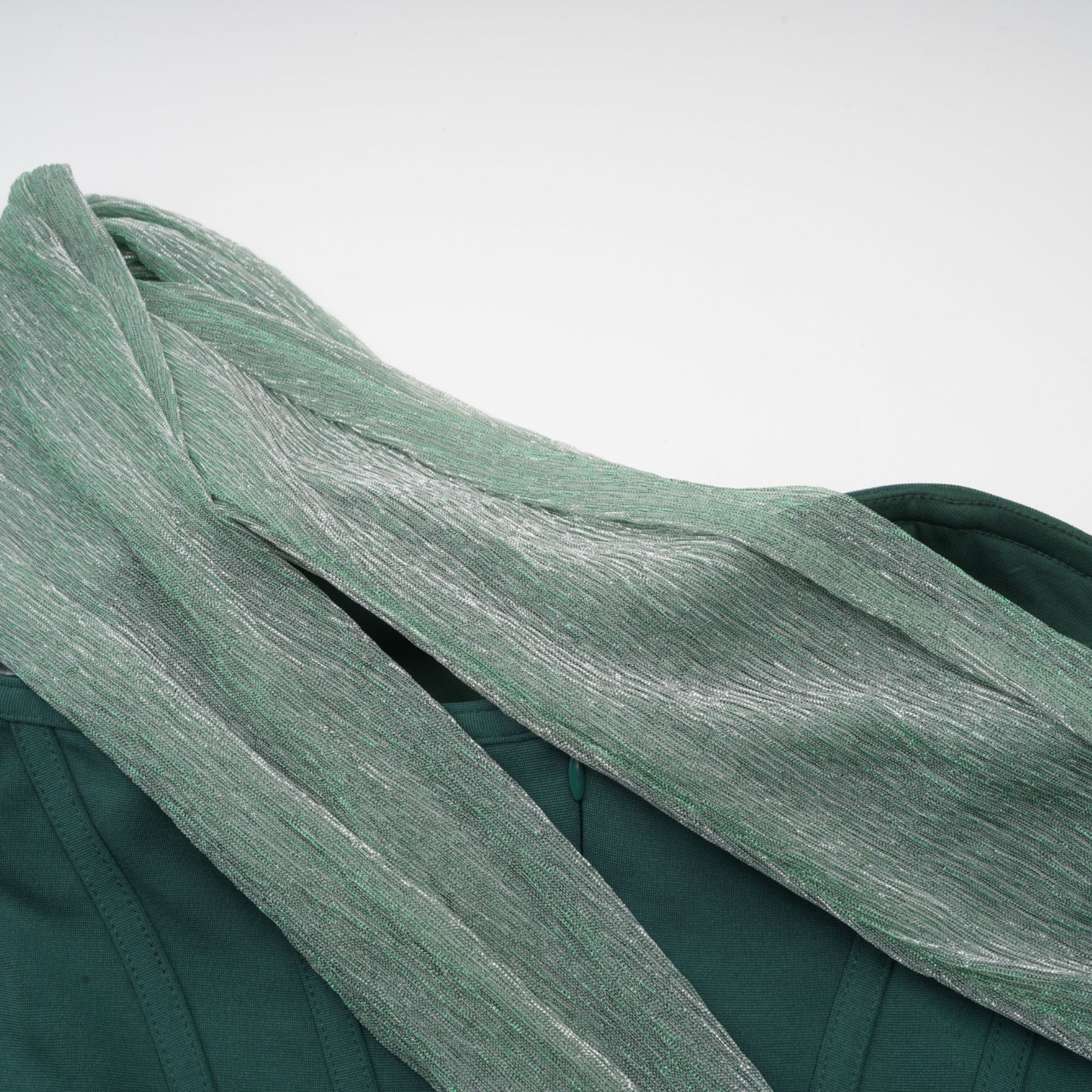 A green maxi dress with corset bodice featuring ribbon design details and long flowing skirt