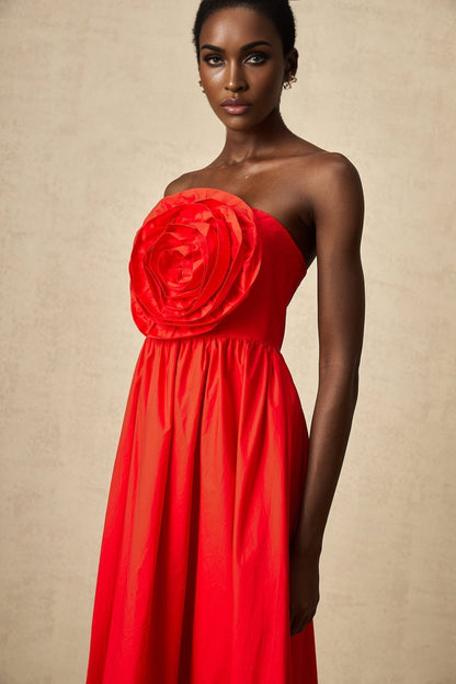 Woman wearing long red maxi dress with ruffled 3d petal details