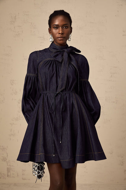A dark blue denim mini dress with contrasting lightcolored stitching named Mirabel