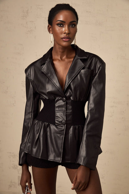 Woman wearing black leather jacket with panelled design front view