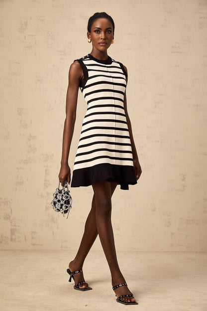 A black mini dress with horizontal stripes in a knit fabric The dress features a simple design and a short length