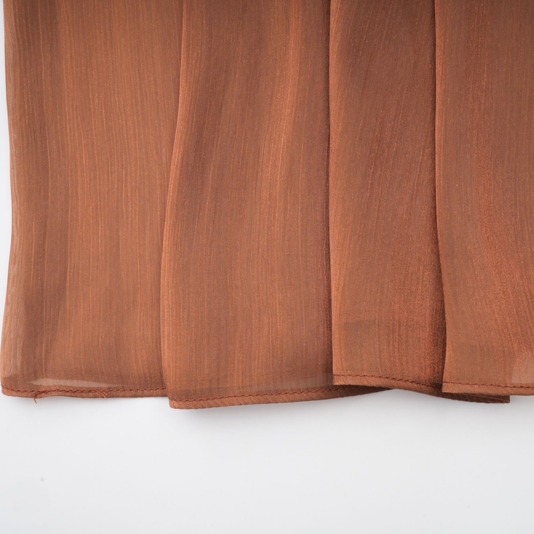 Brown pleated satin maxi dress with long flowing skirt and elegant design