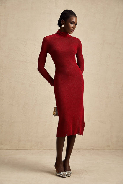 Woman wearing a red metallic midi dress with pointelle knit pattern and sleeveless design standing in a neutral background