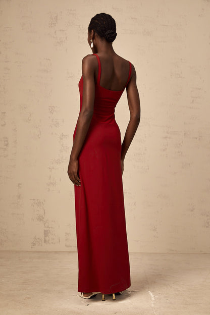 A long red maxi dress with sheer tulle panels designed by Celine