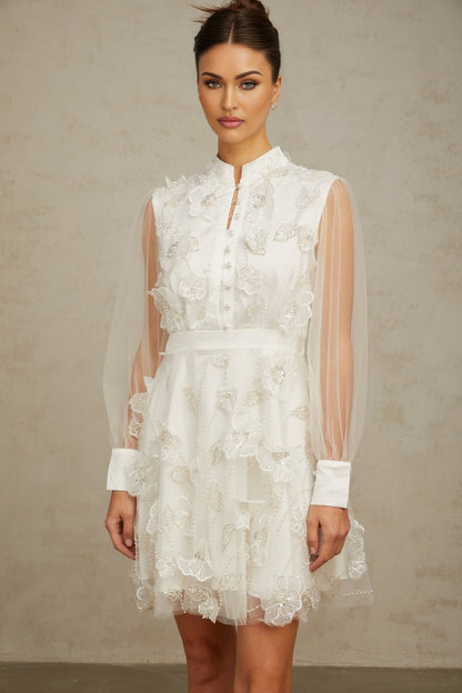 Short white mini dress with 3D floral tulle petals covering the bodice and skirt