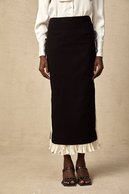 A midi length skirt with color blocked panels featuring the name Heloise