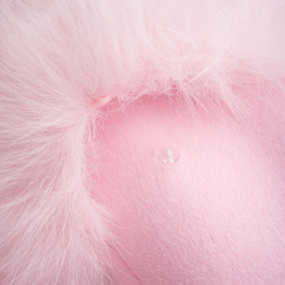 A pink oversized coat made of faux fur with a plush texture and long sleeves
