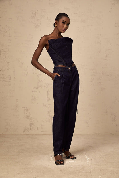 A dark blue off shoulder denim top styled in a casual and feminine design