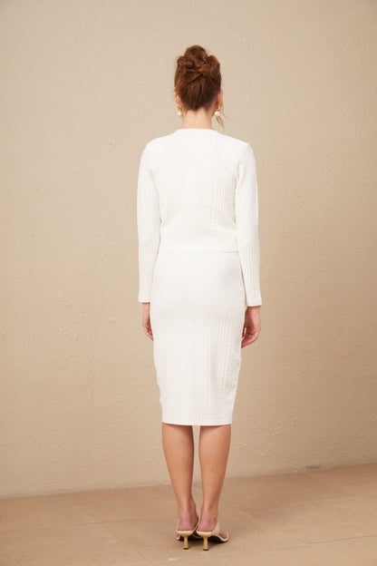 A white knit dress with a monogram pattern featuring the name Margot