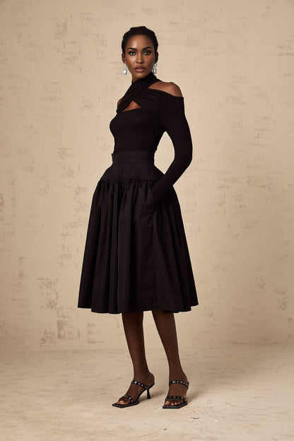 Black pleated midi skirt with flared silhouette named Pauline