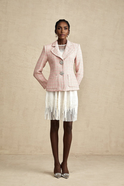 A pink blazer with crystal embellishments made from checked tweed fabric