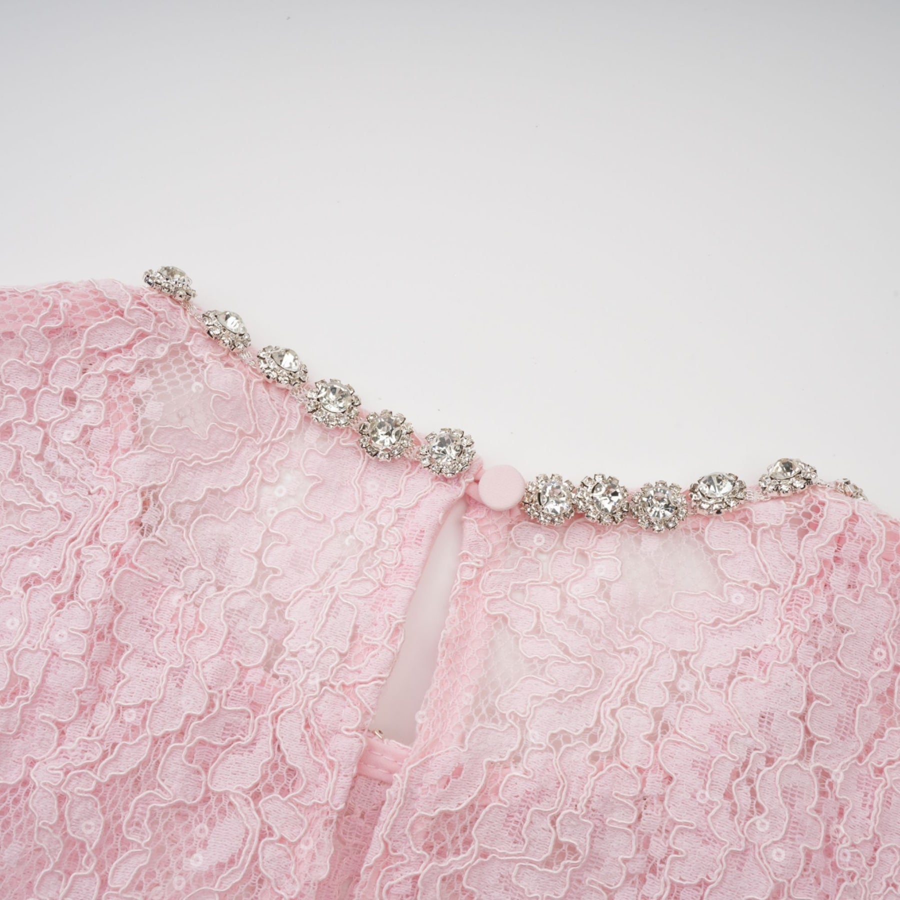 A pink lace midi dress with floral embroidery and embellishments created by Elisabetta featuring delicate details throughout the garment