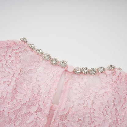 A pink lace midi dress with floral embroidery and embellishments created by Elisabetta featuring delicate details throughout the garment