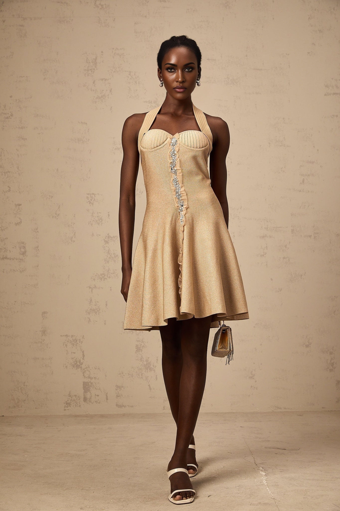 A khaki colored mini dress with knitted fabric and embellished details featuring a short length and likely named Gabrielle