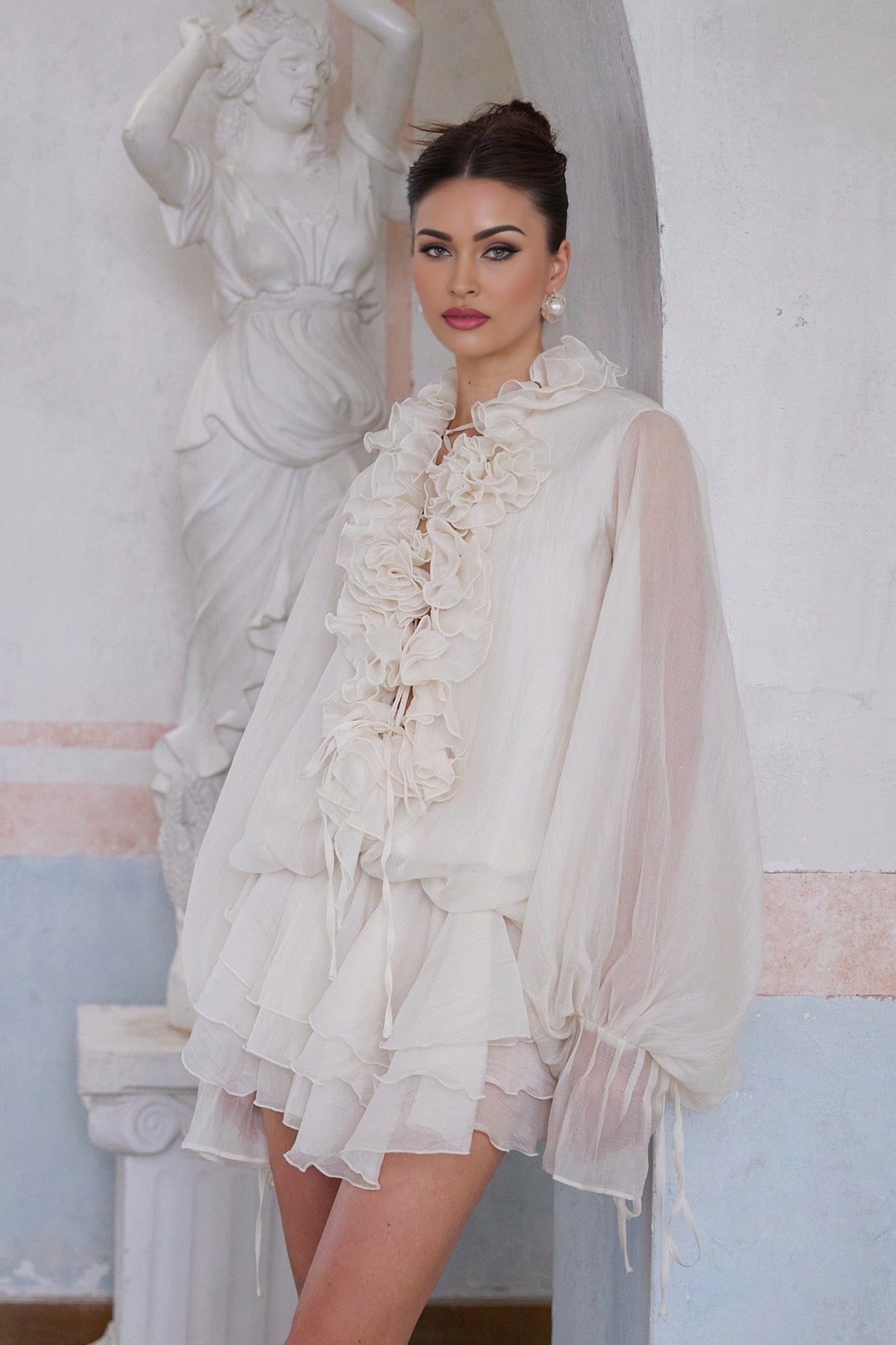 A short neutral colored tiered mini dress with floral applique details called Zephyrine
