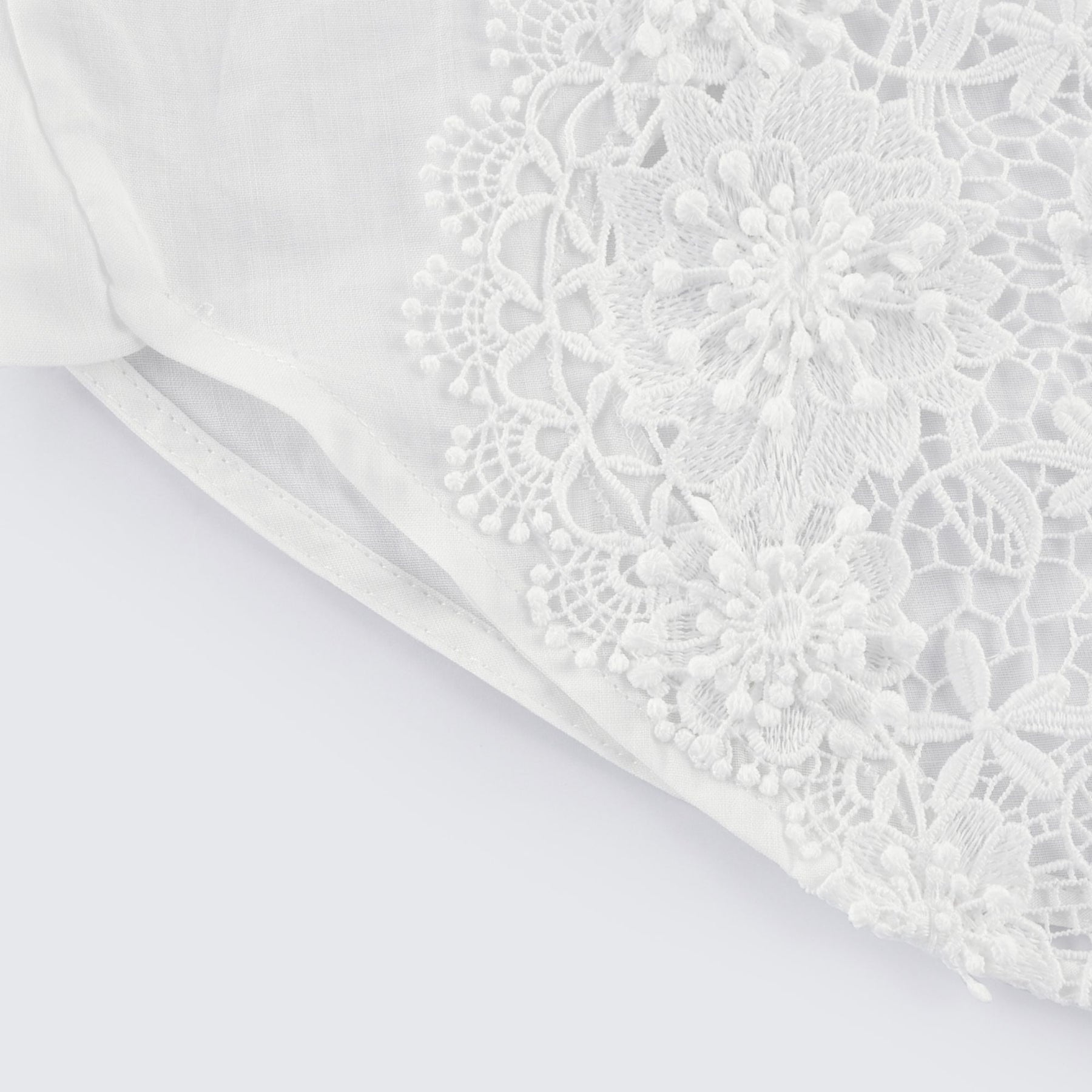 White shirt with lace embroidery and cut out details