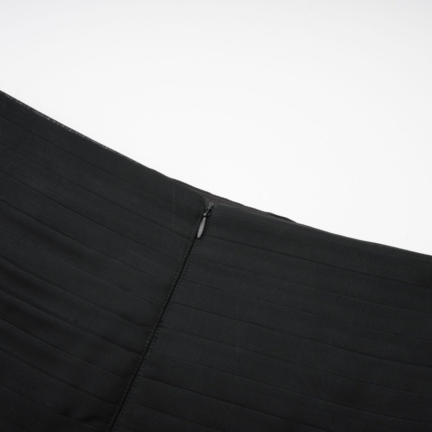 Woman wearing long flowy maxi skirt with ruffles and pleats in soft tulle fabric