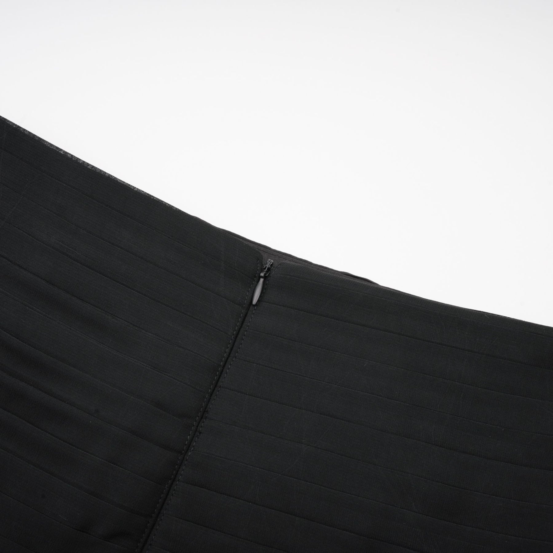 Woman wearing long flowy maxi skirt with ruffles and pleats in soft tulle fabric