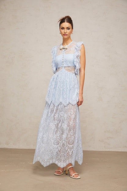 Woman wearing a long blue lace maxi dress with layered skirt and capucine neckline