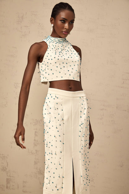 Woman wearing offwhite matching set with embellished top and skirt